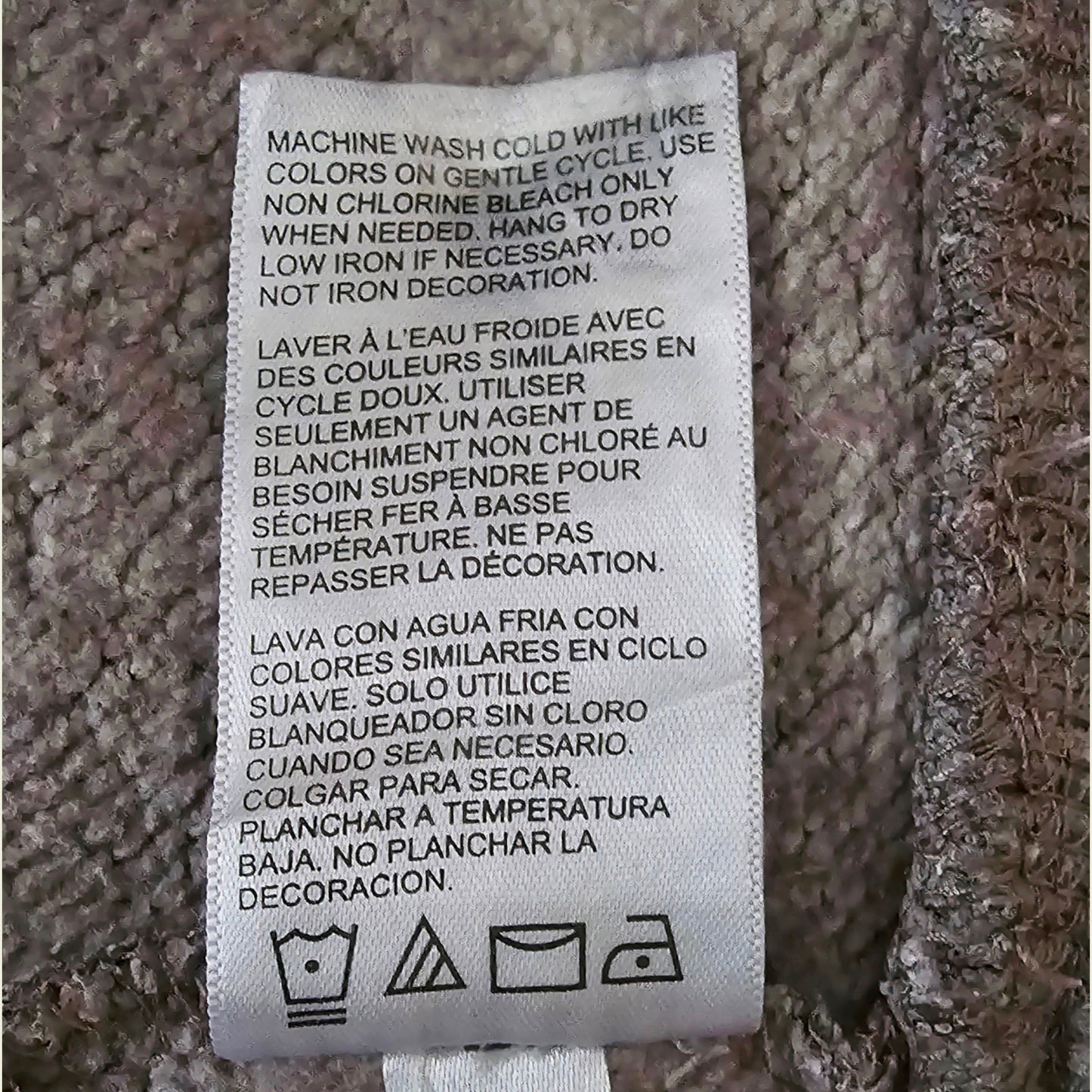 Washing instructions label on a textured fabric background