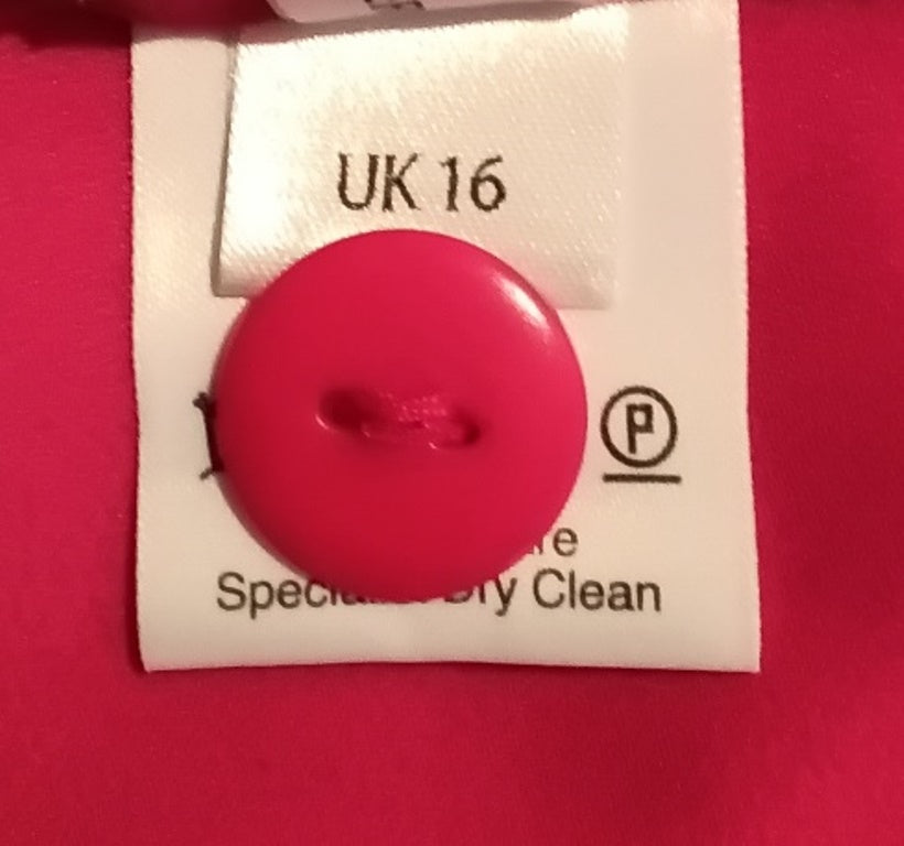Pink button on a label with text and a logo on a red background