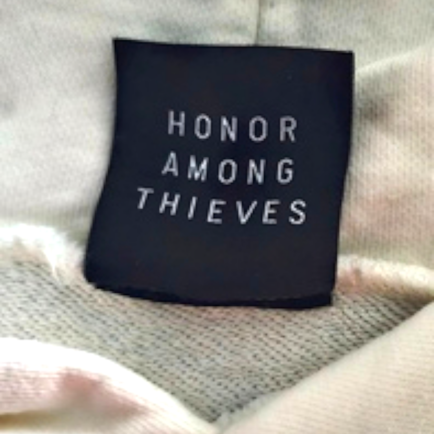 Black label with 'Honor Among Thieves' text on a textured surface