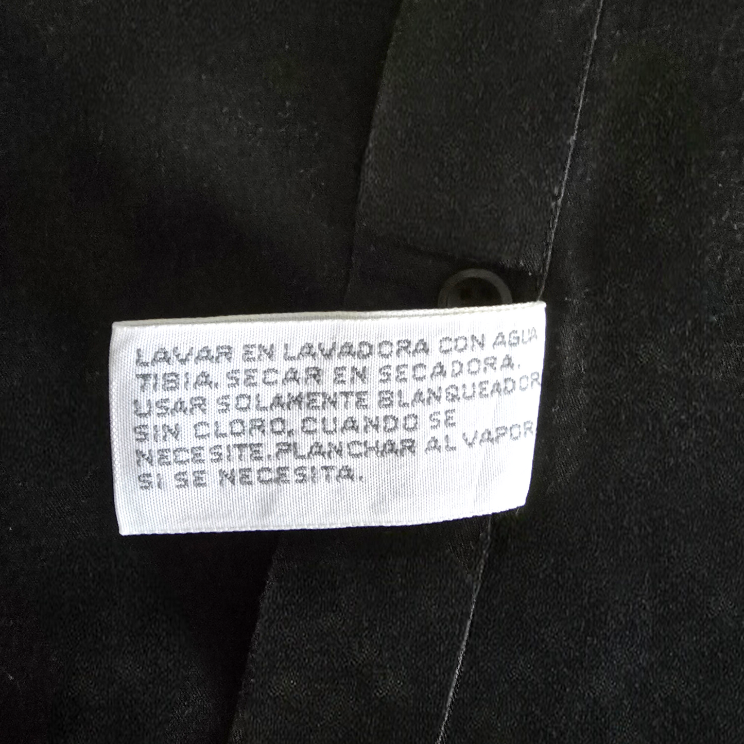 Clothing label on a black fabric background