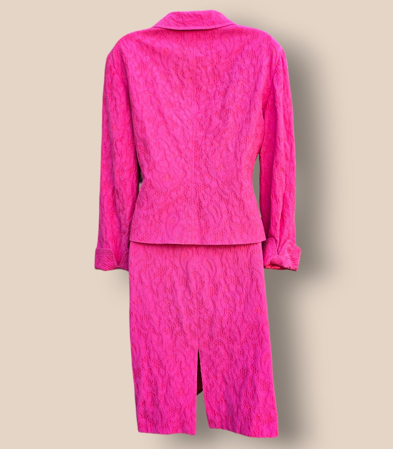 Pink textured suit on a beige background