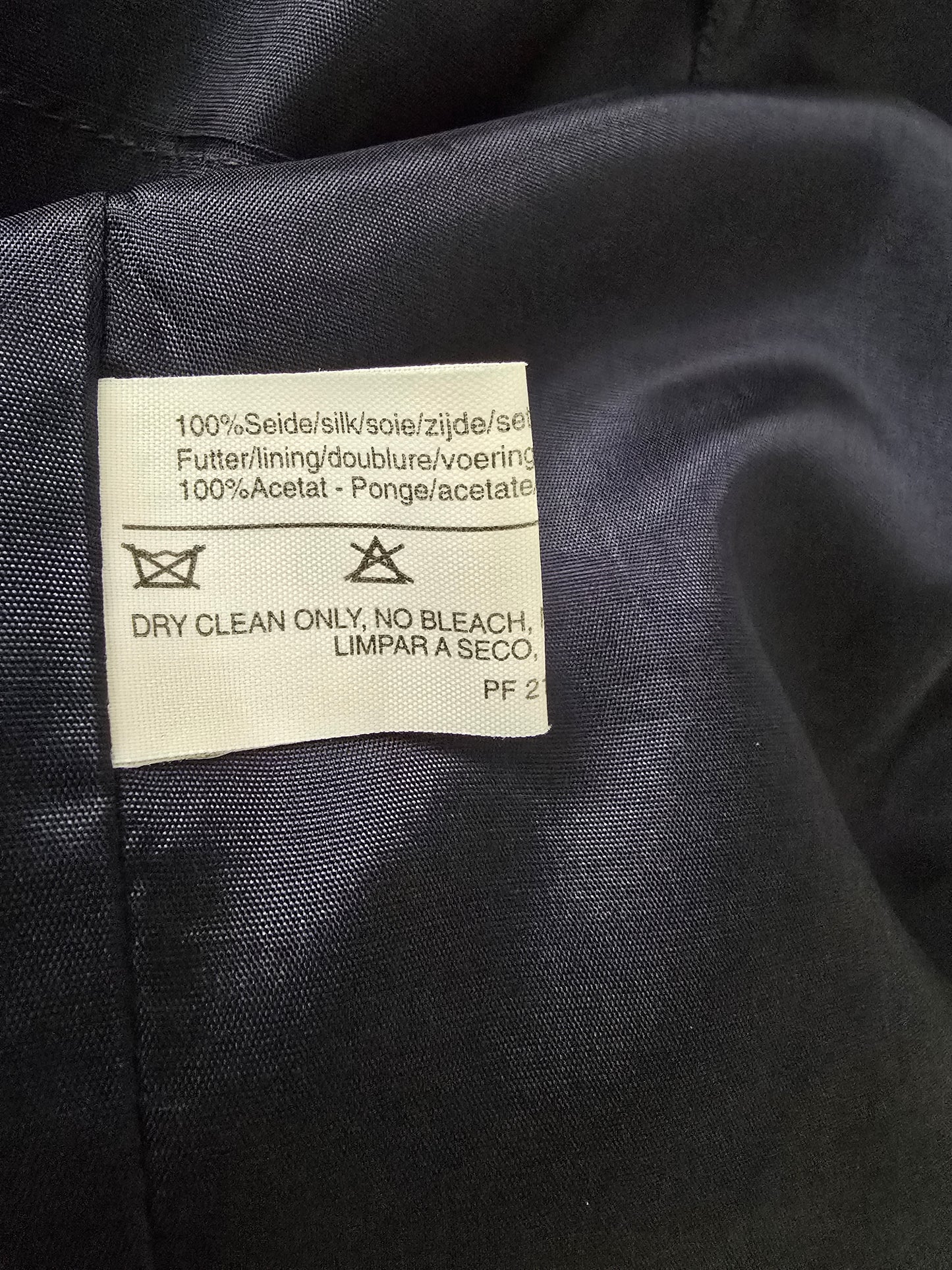 Clothing label on a dark fabric background