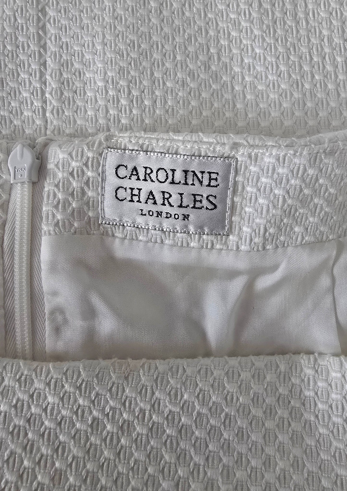 Textile with a visible brand label on a textured fabric background