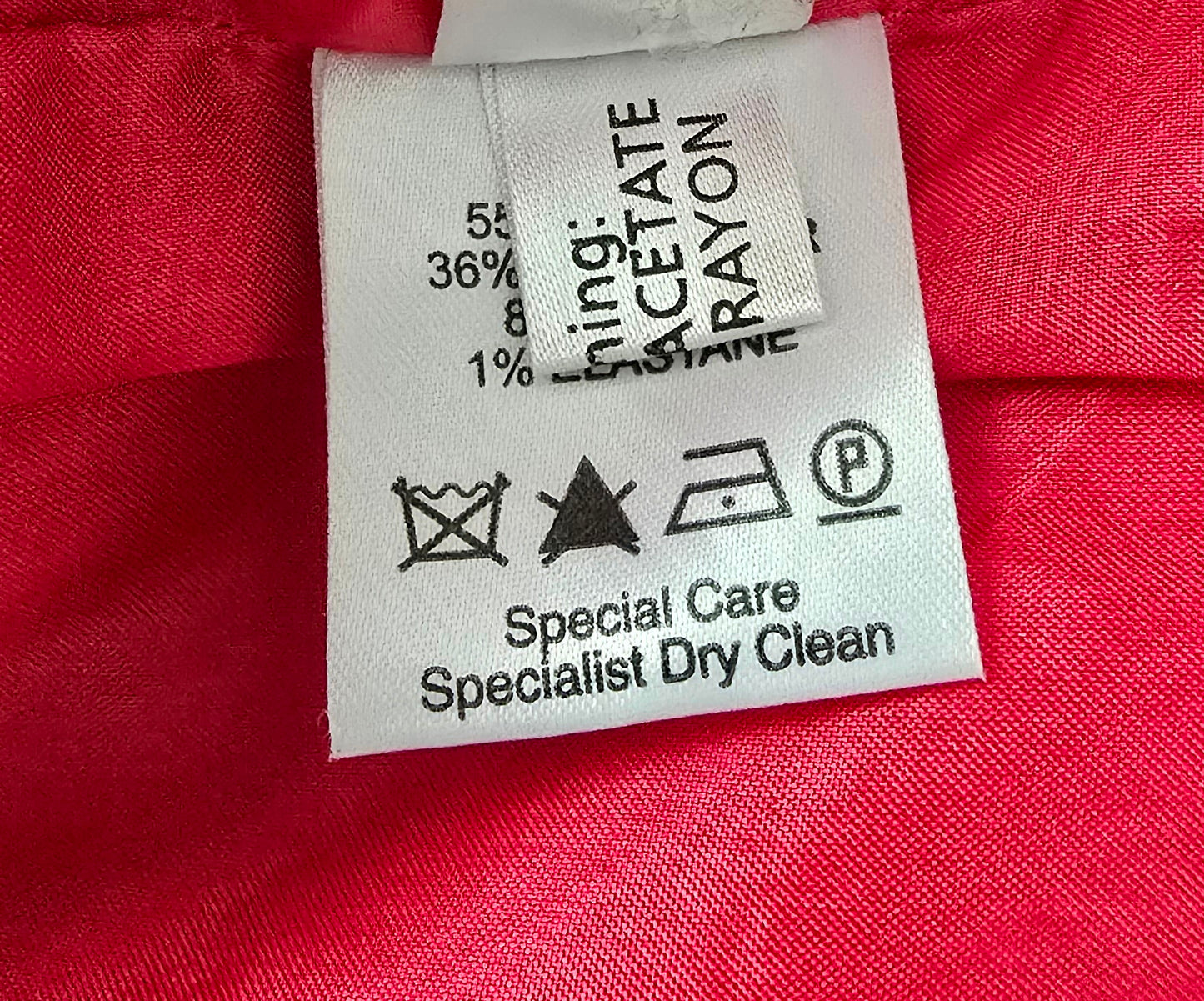Clothing label on a red fabric background