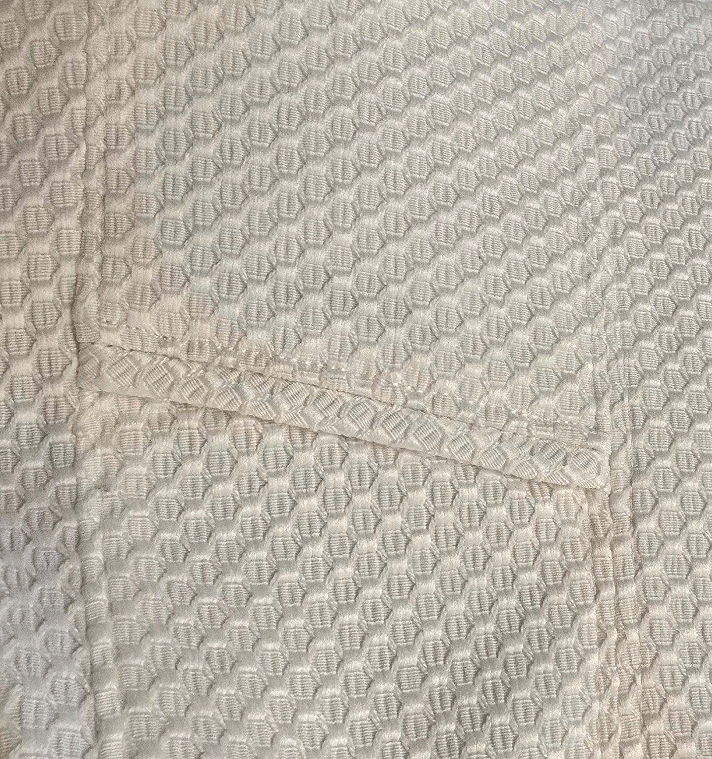 Textured white fabric with a subtle pattern