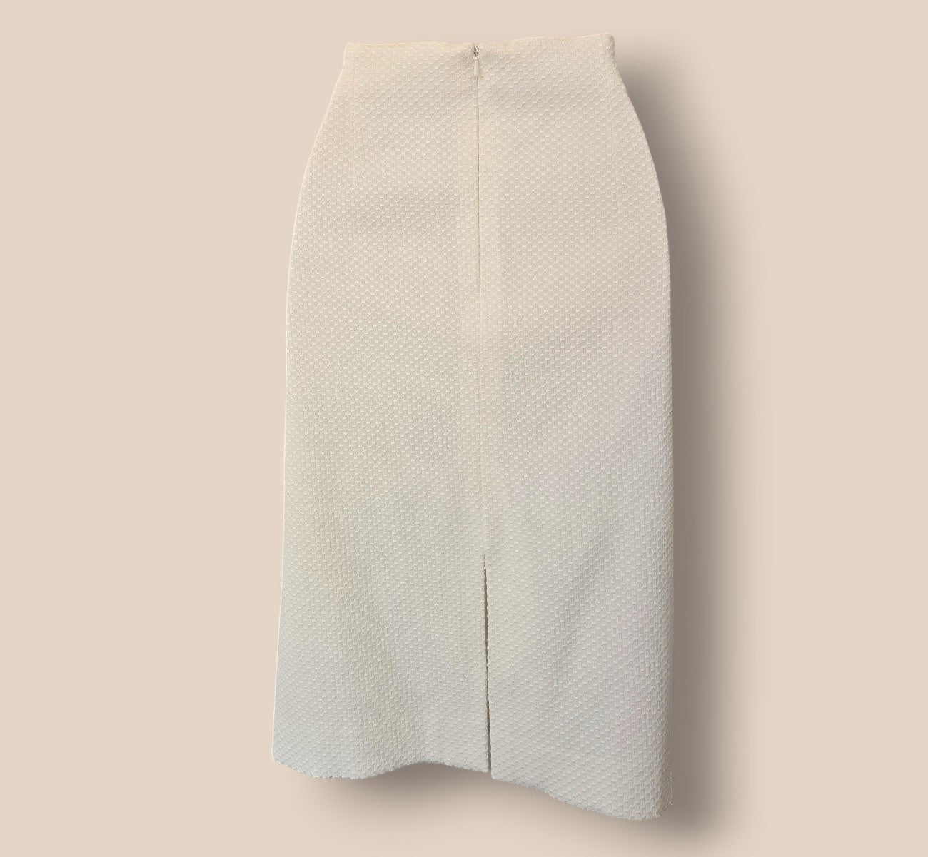White textured skirt on a beige background