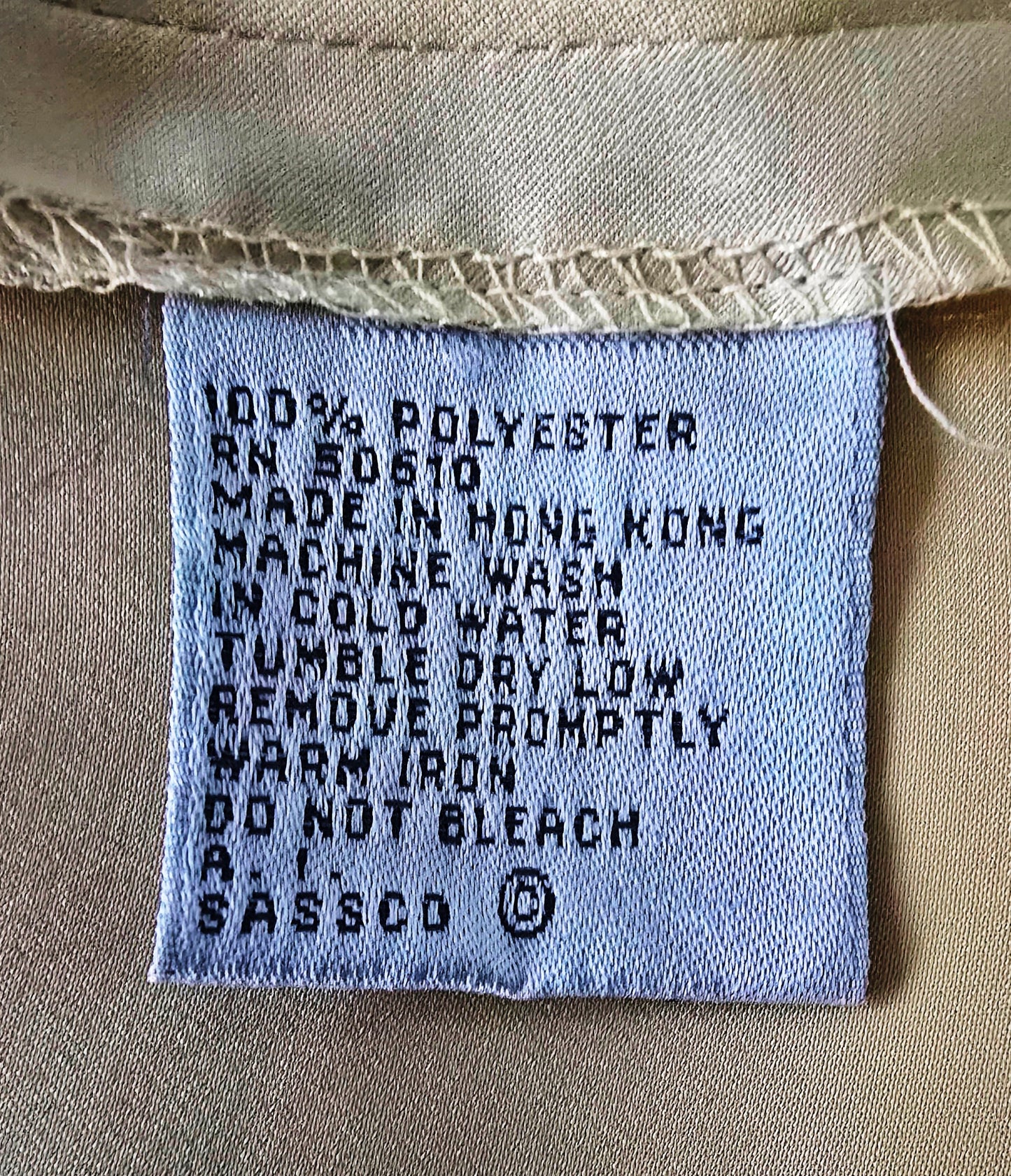 Fabric tag with washing instructions on a beige background