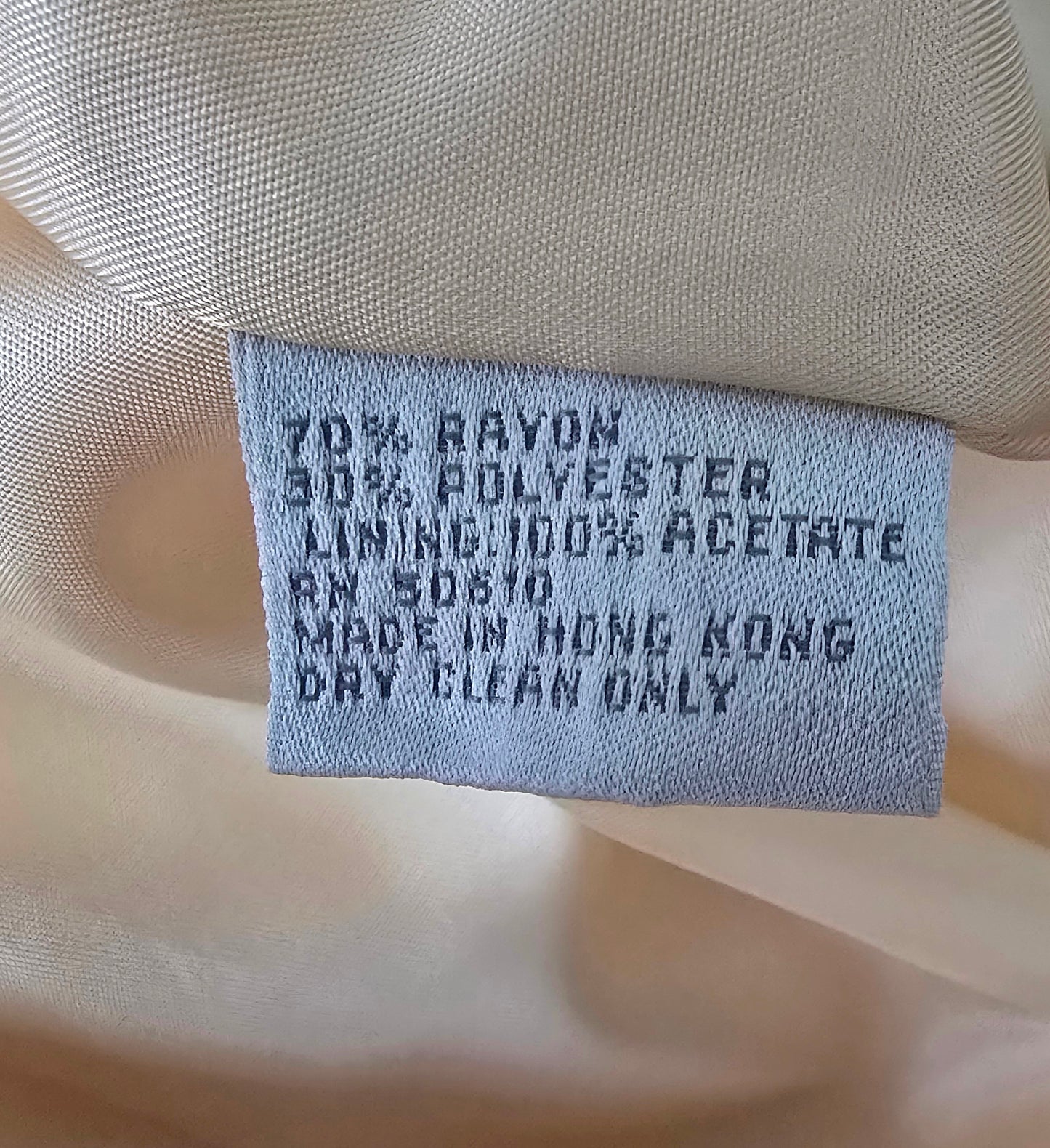Textile label on fabric with details about material and care instructions.