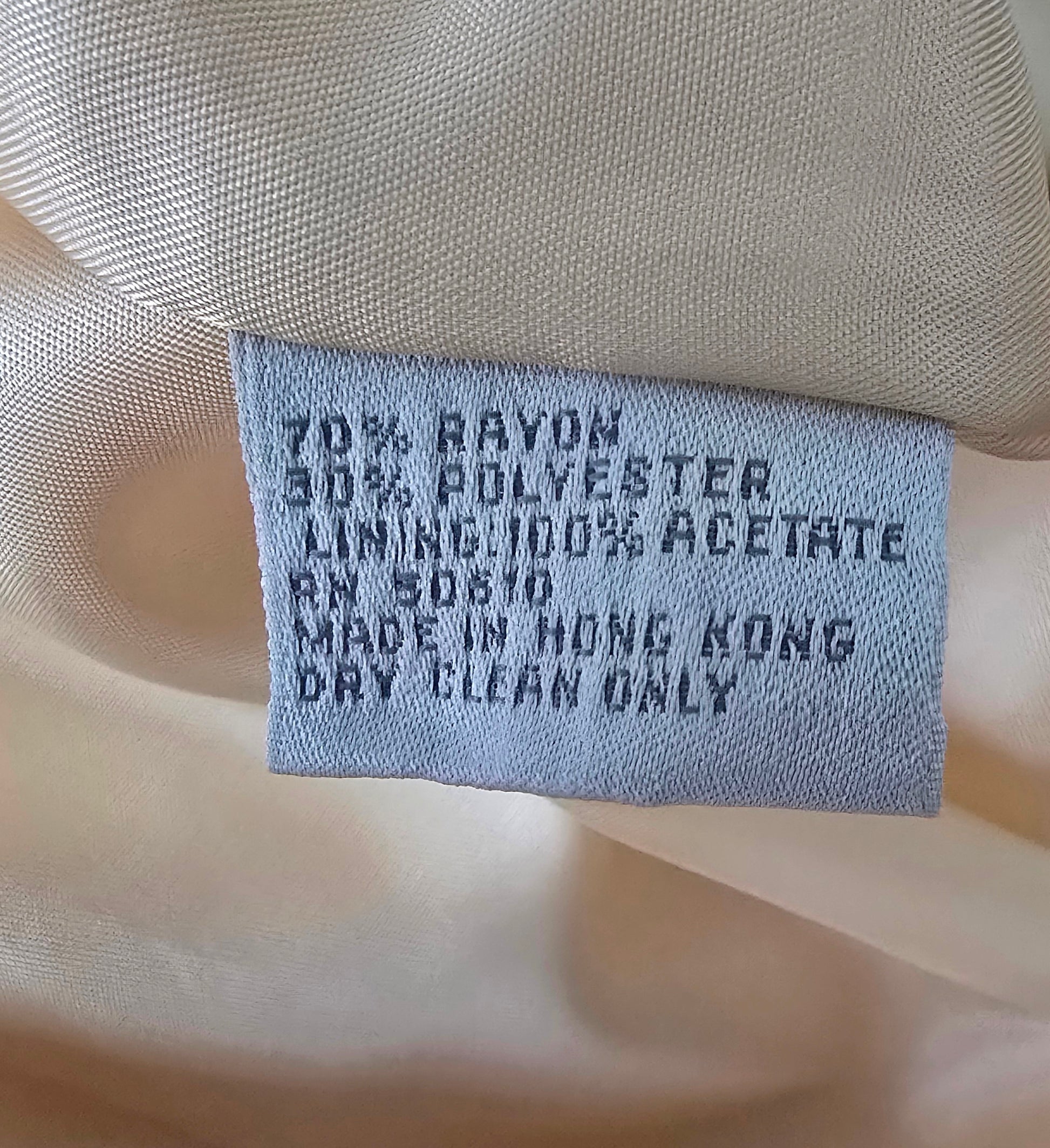 Textile label on fabric with details about material and care instructions.