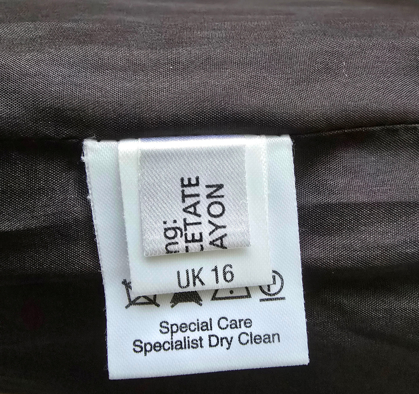 Clothing label on a dark fabric background