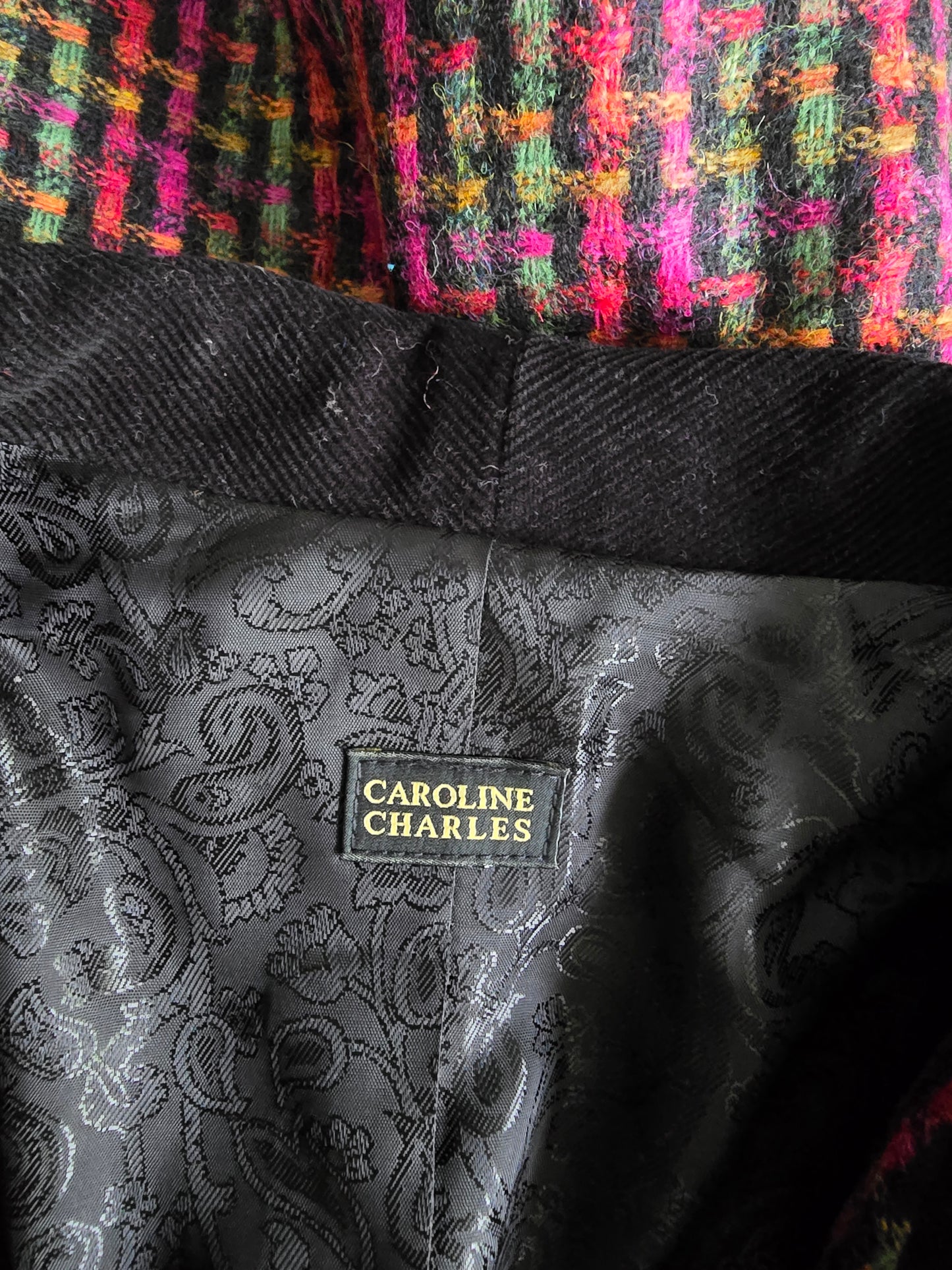 Close-up of a textured fabric with a brand label on a multicolored background
