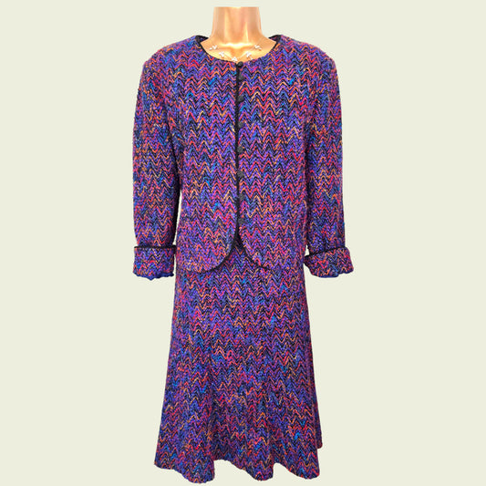 Multicolored patterned dress on a mannequin against a plain background