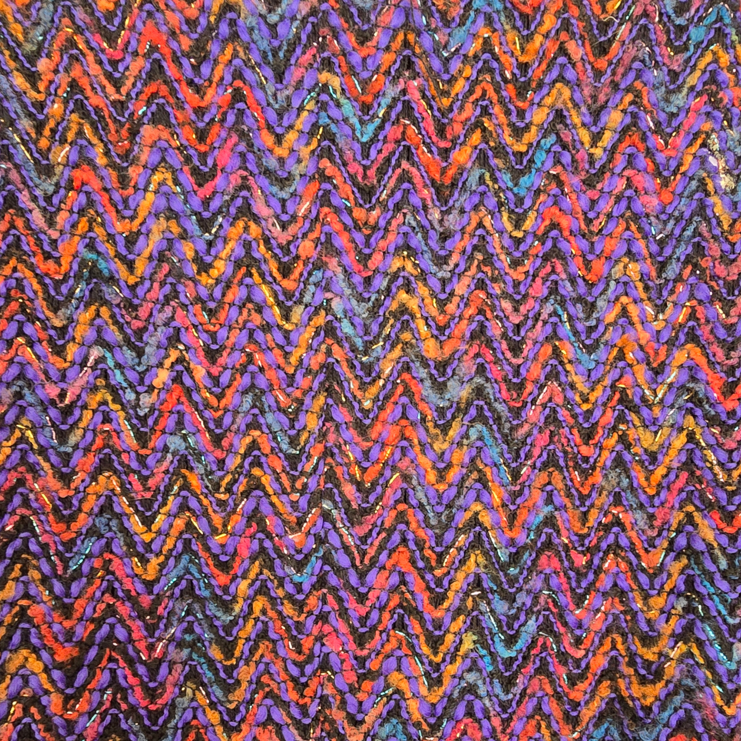 Multicolored zigzag pattern on a textured fabric background