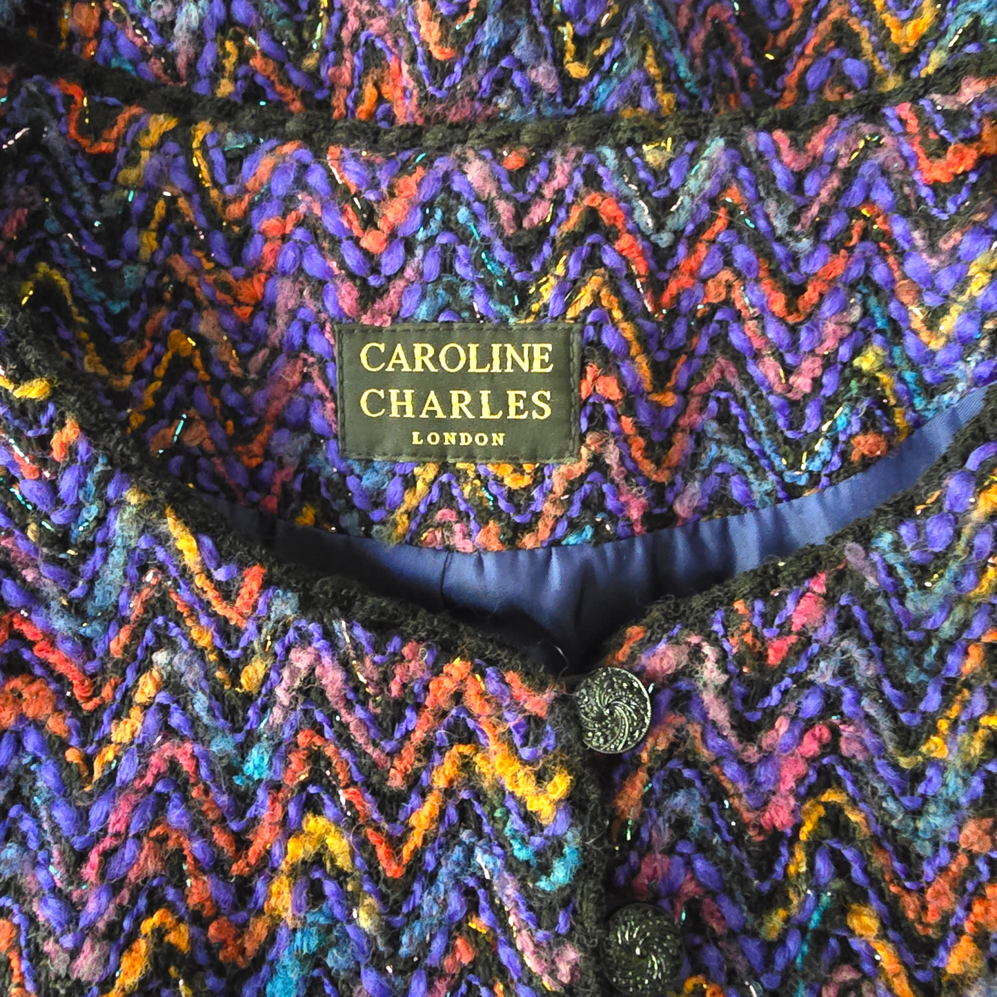 Multicolored zigzag patterned fabric with 'Caroline Charles London' label