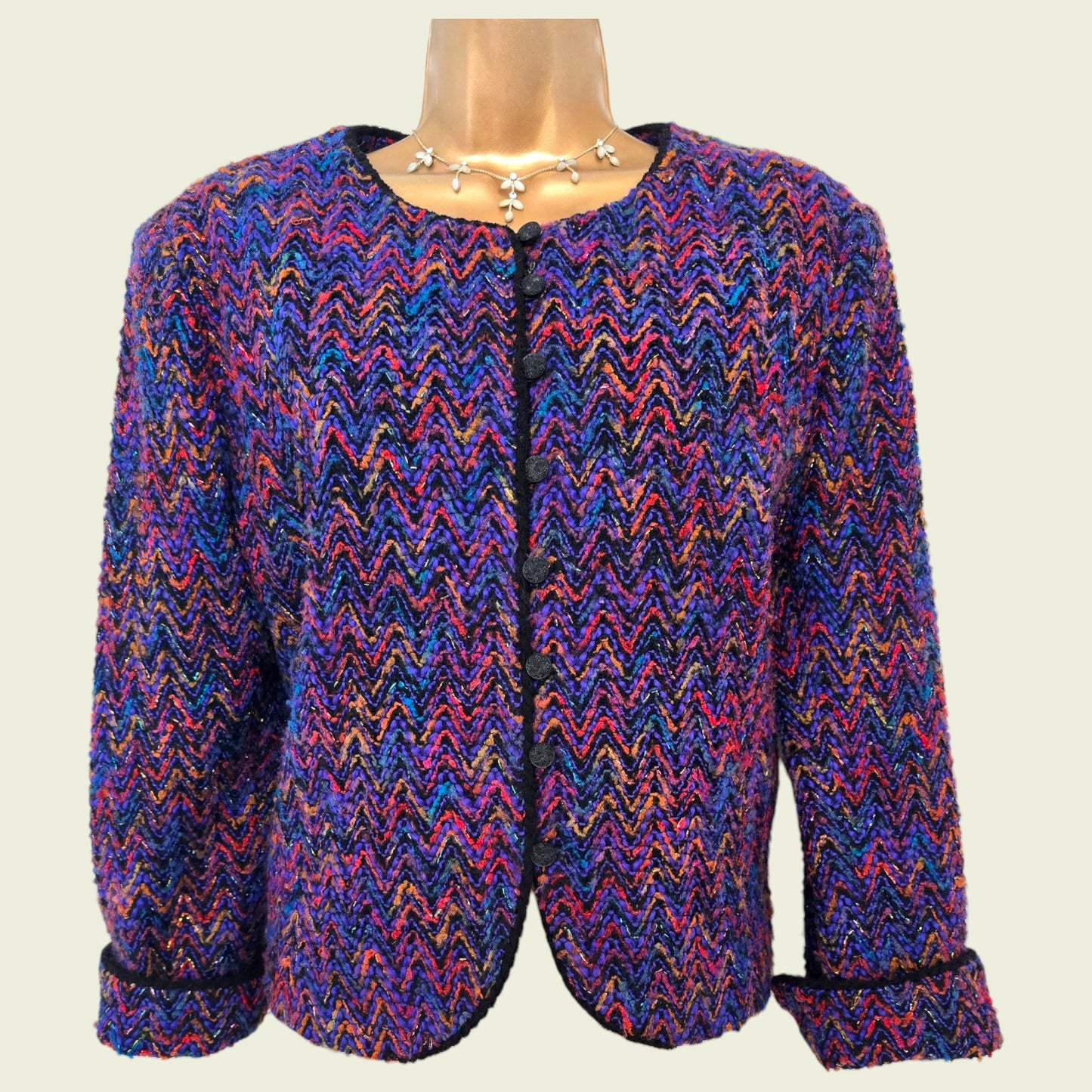 Multicolored patterned jacket on a mannequin against a plain background