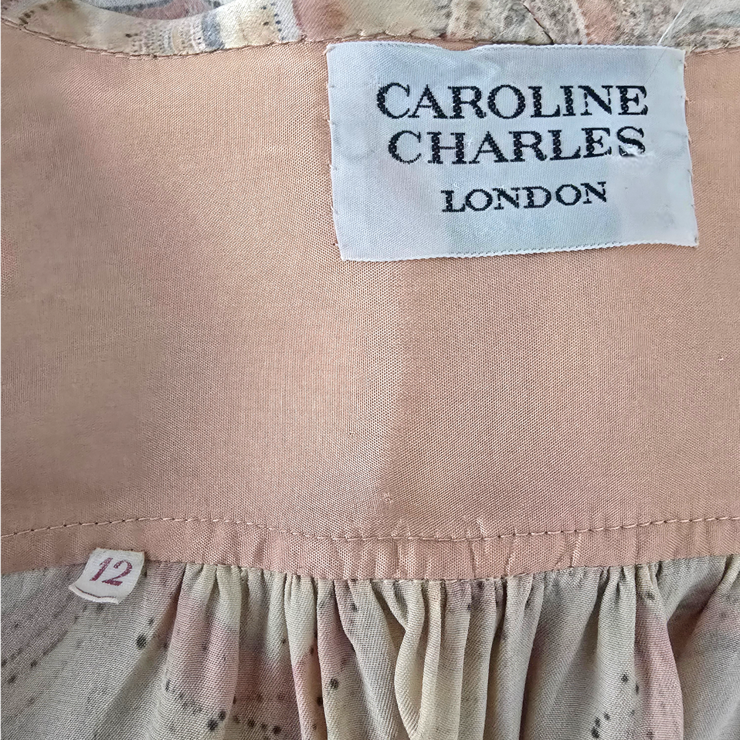 Clothing label with 'Caroline Charles London' on a garment.