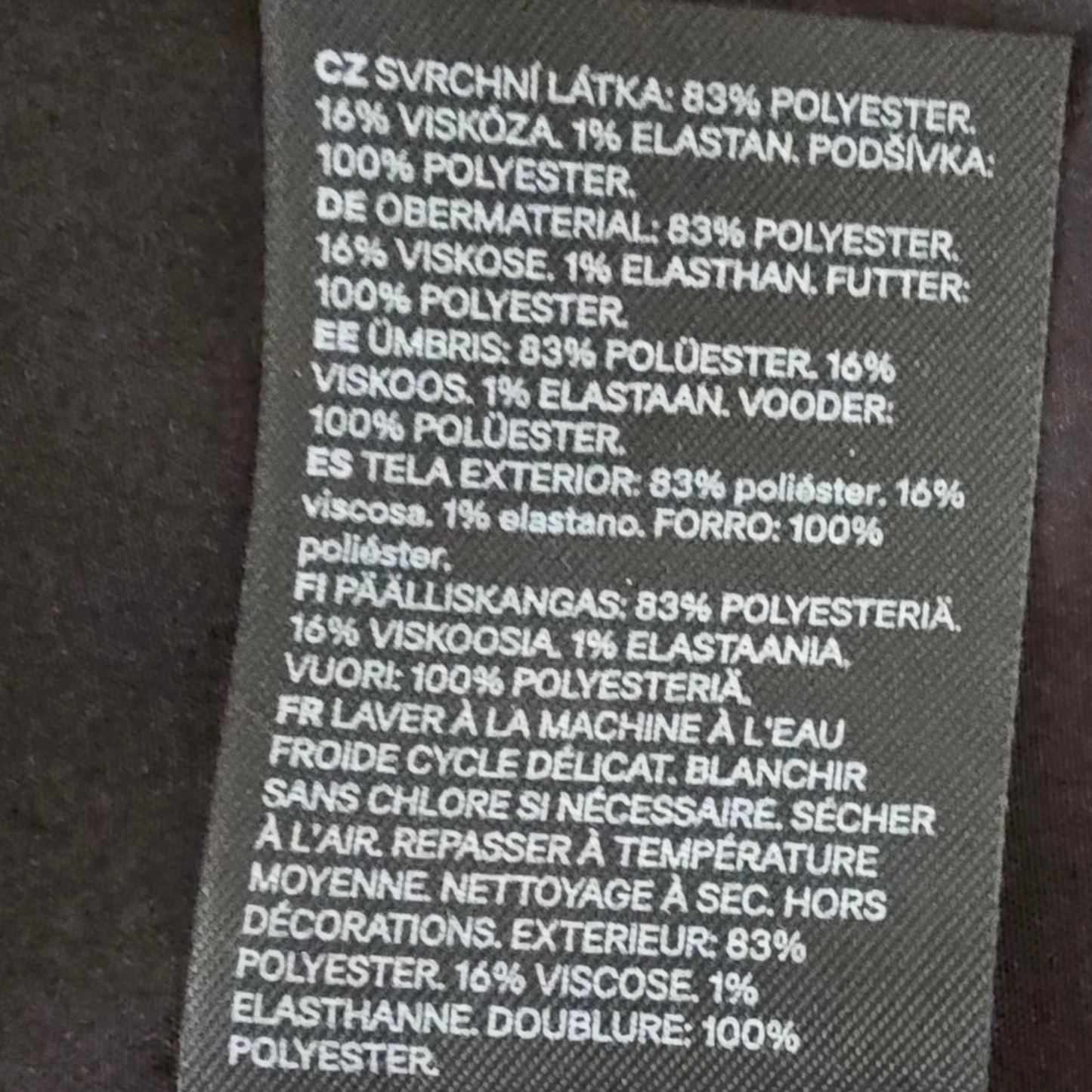Textile label with material composition details on a dark background