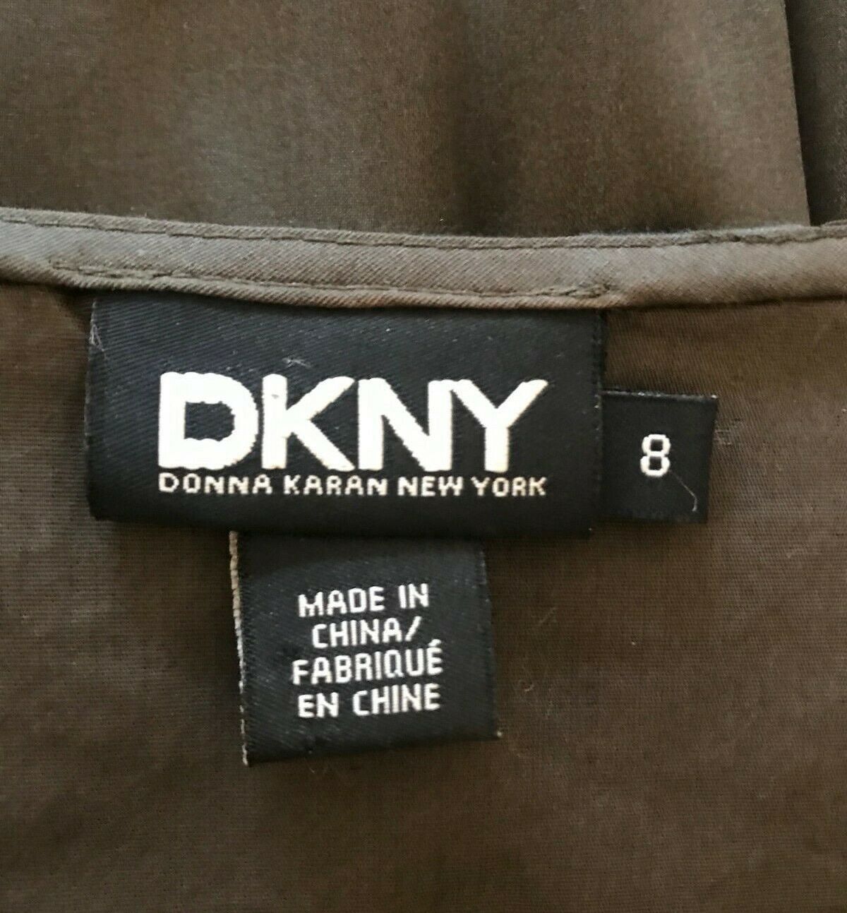 DKNY label on a brown fabric background