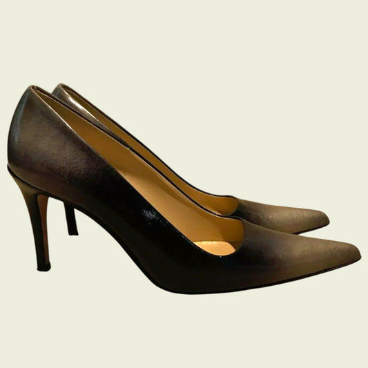 Pair of brown high-heeled shoes on a beige background