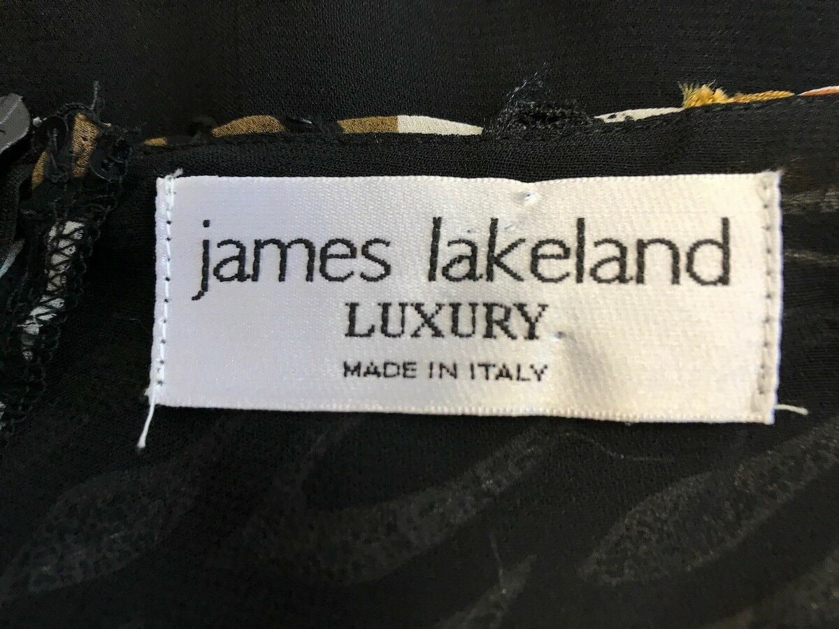 Label with 'james lakeland Luxury Made in Italy' on a dark fabric background