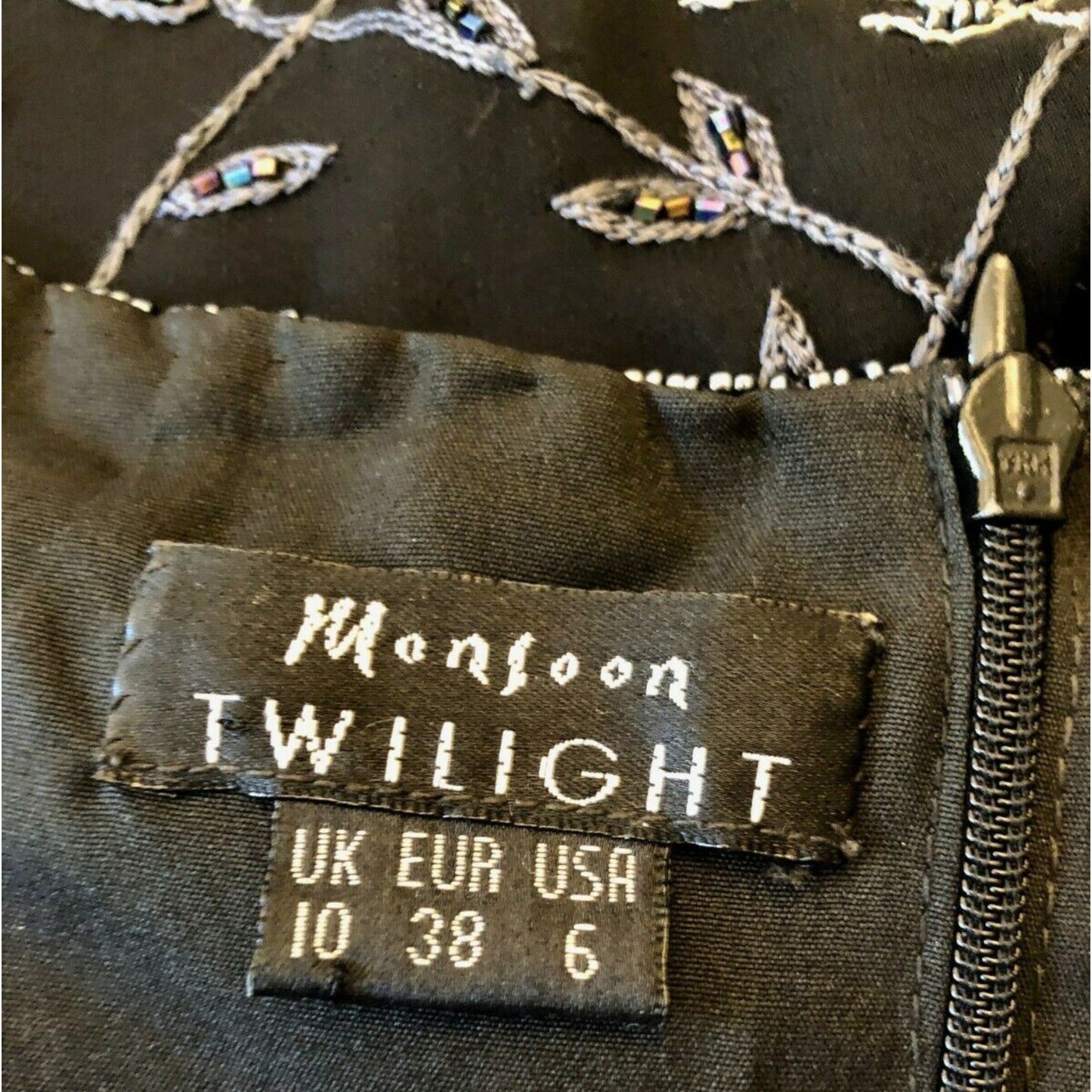 Label on a garment with 'Monsoon Twilight' branding and size information.