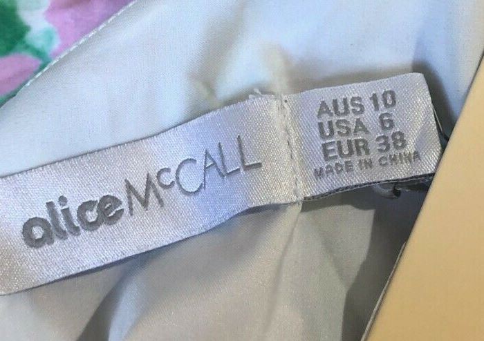 Label with 'alice McCall' branding on a garment, showing size information.