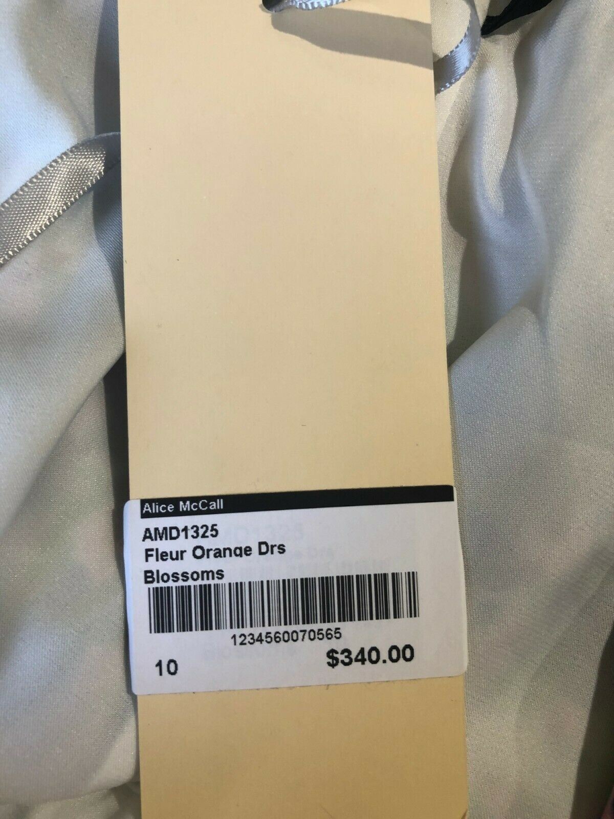 Dress with a label showing product details and price.