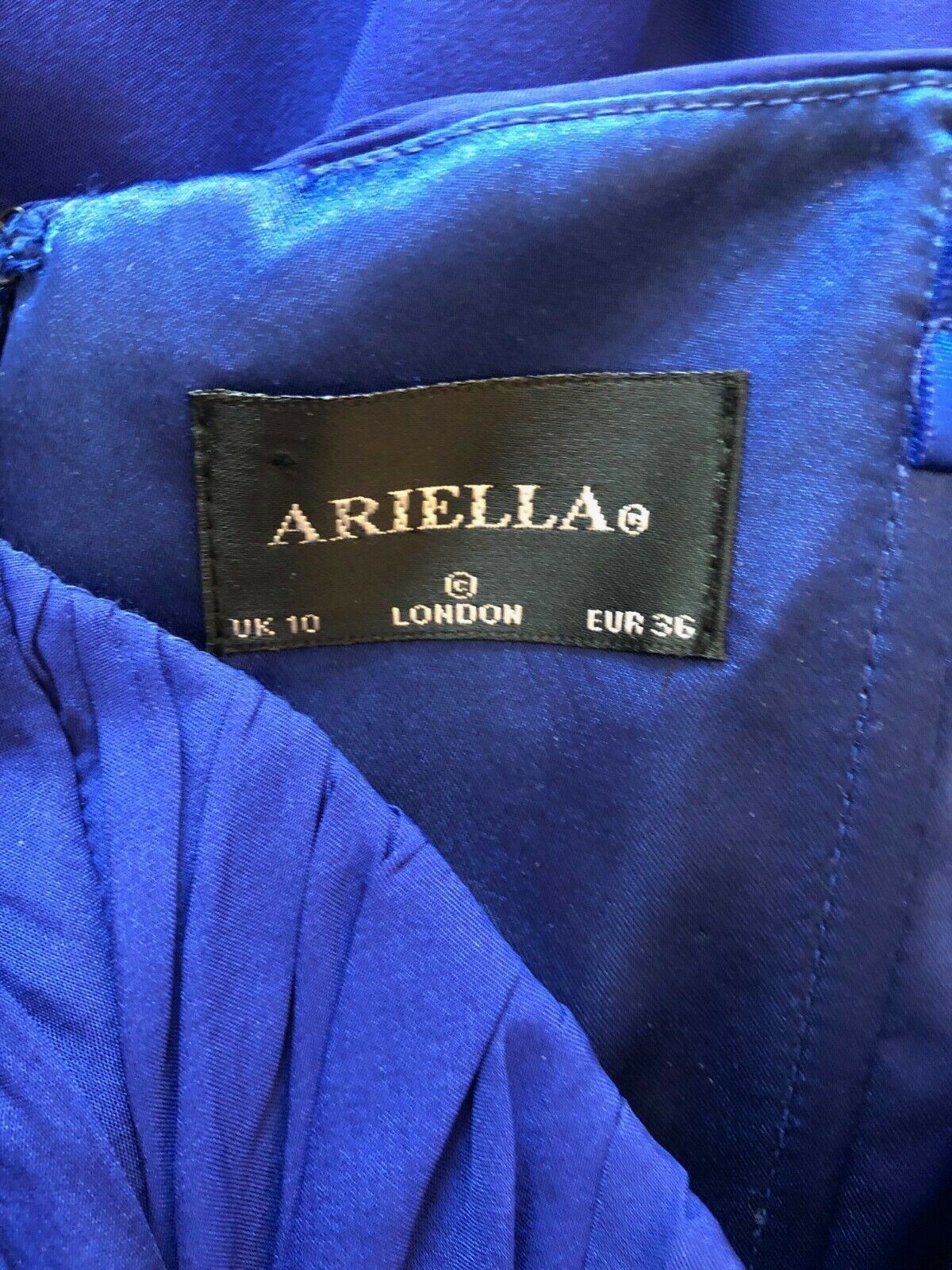 Ariella label on a blue fabric background