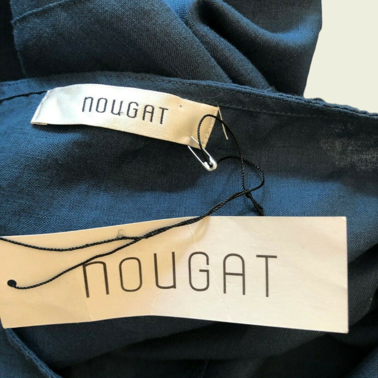 Nougat brand label on a dark fabric background