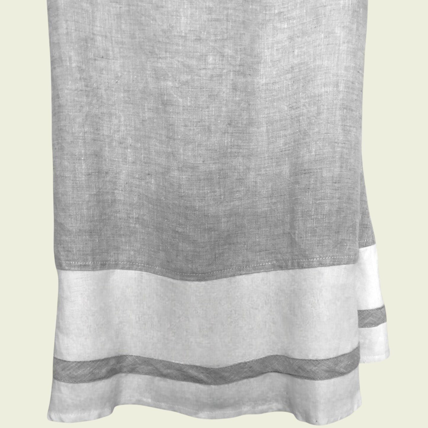 Gray and white dress with a subtle pattern on a light beige background