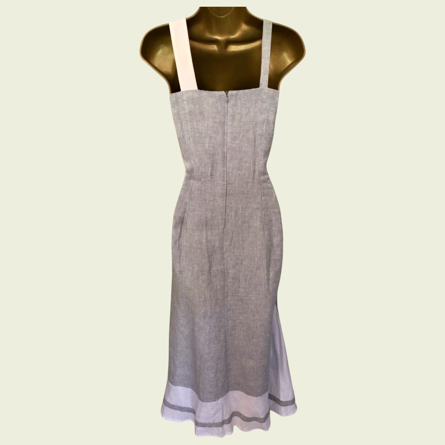 Gray apron on a mannequin against a light green background