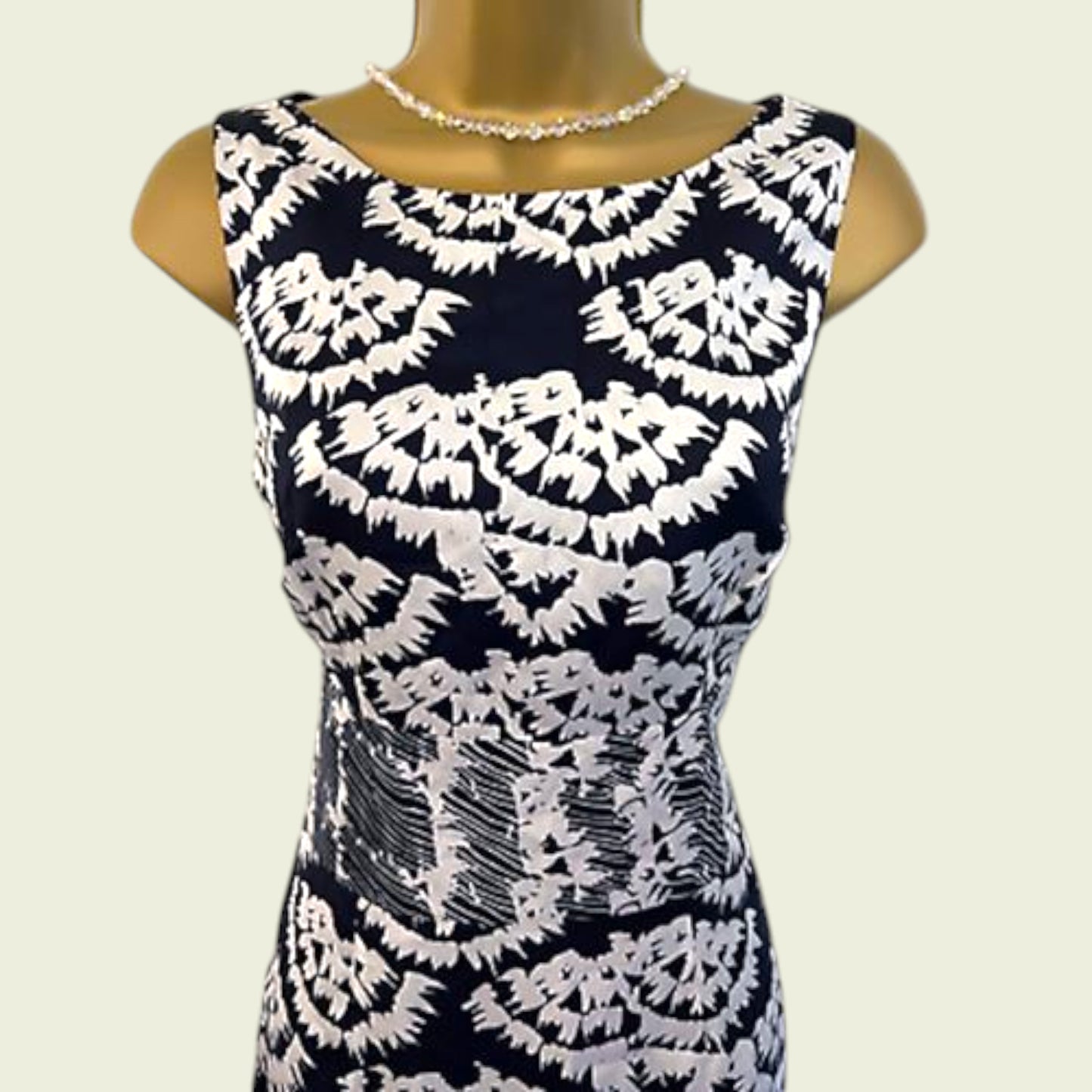 Black and white patterned dress on a mannequin against a beige background
