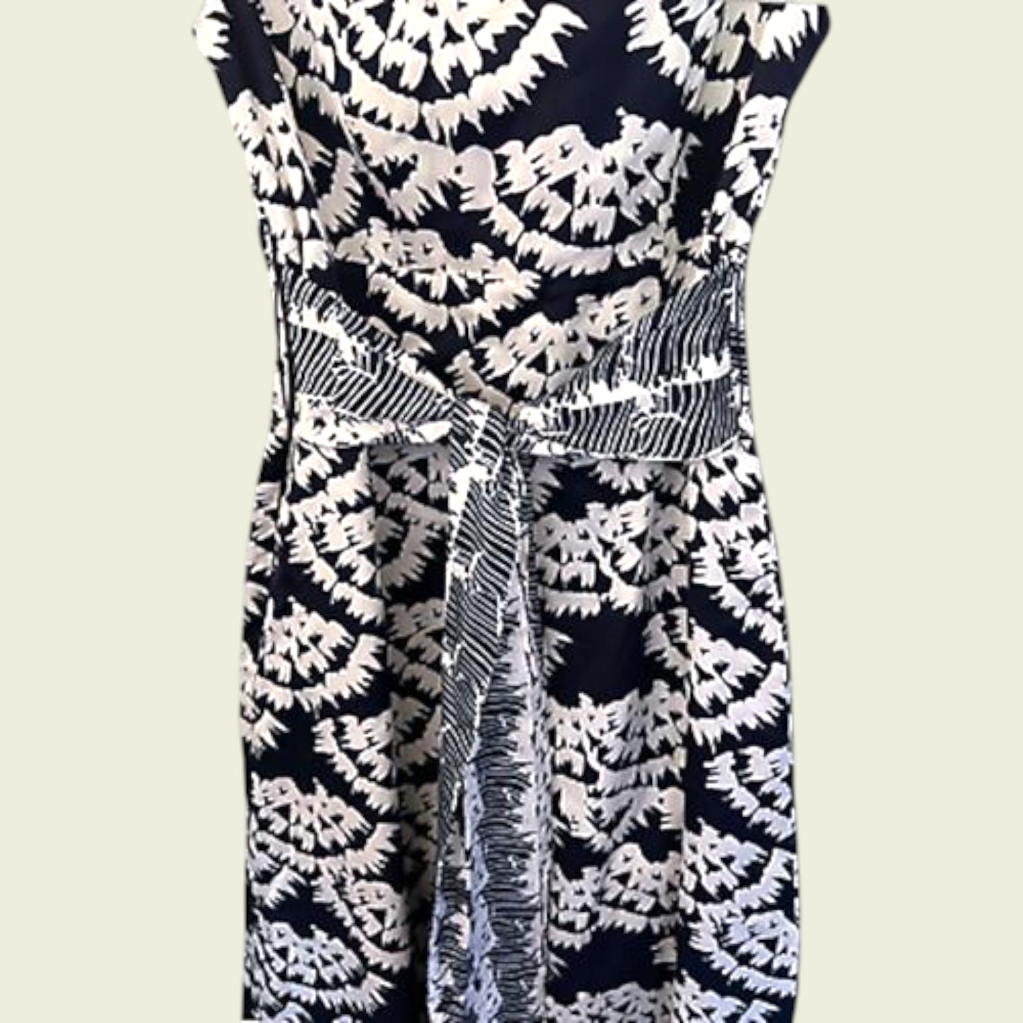 Navy blue dress with white floral pattern on a plain background