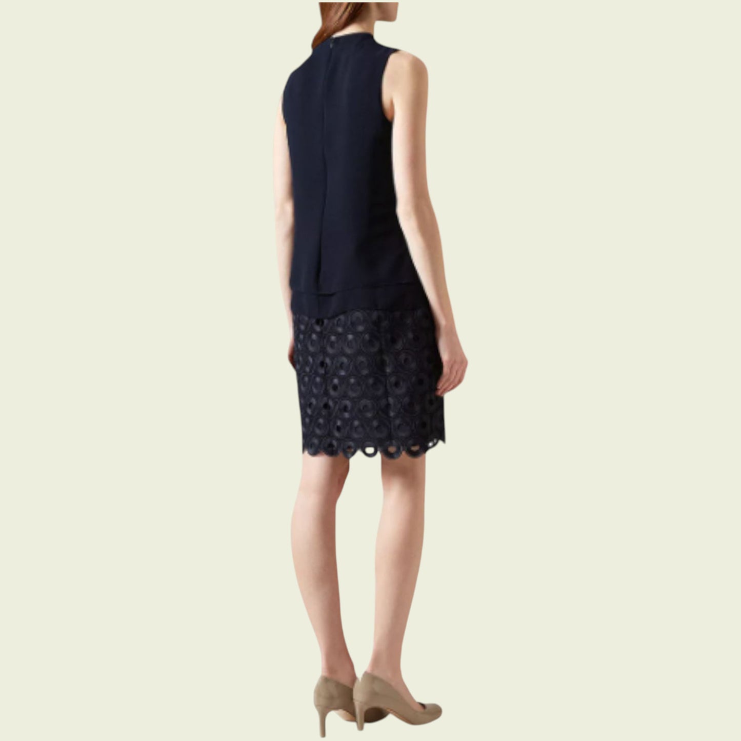 Navy dress with lace detailing on a beige background