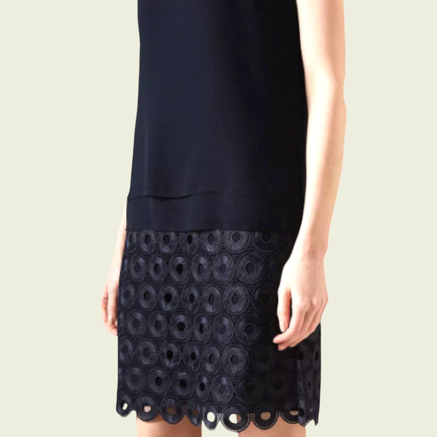 Navy dress with lace detailing on a beige background