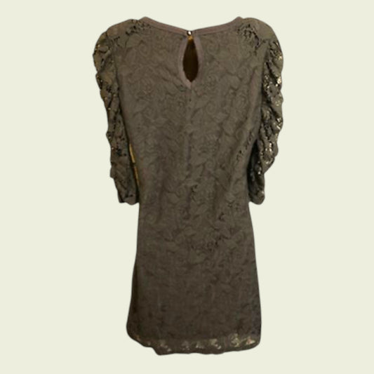 Brown lace dress with ruffled sleeves on a beige background