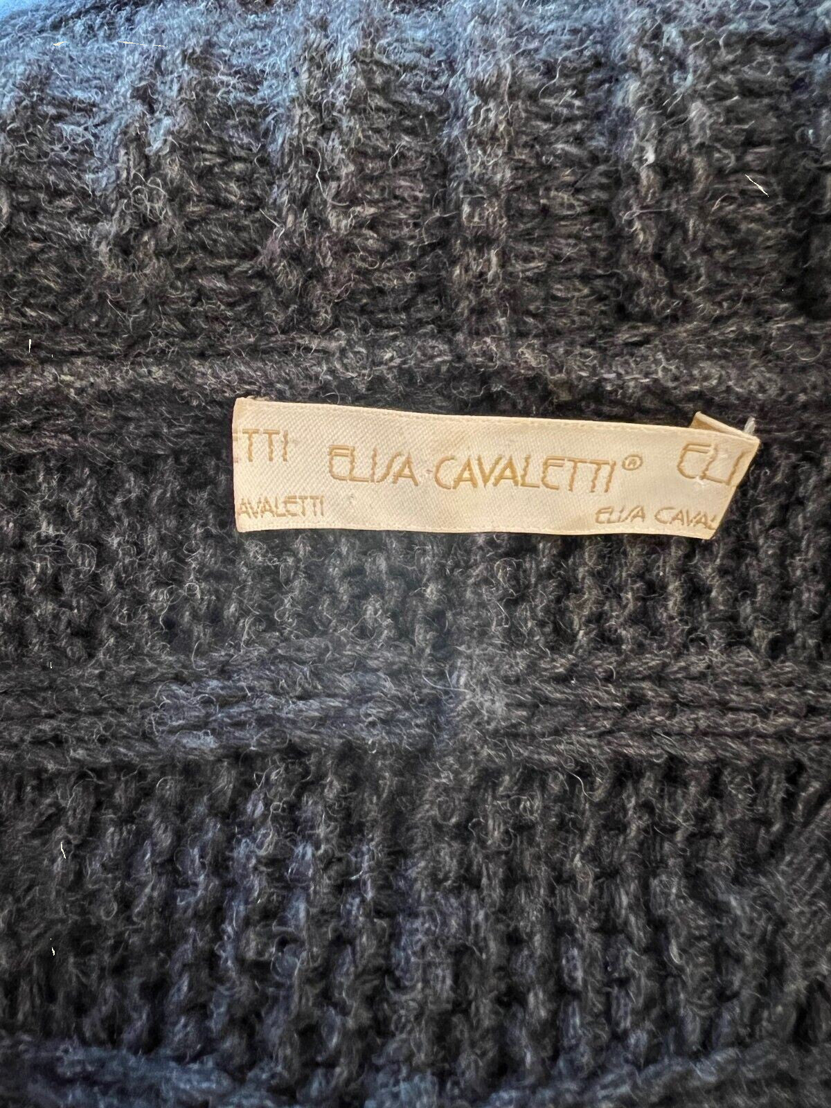 Close-up of a textured fabric with a brand label on a dark background