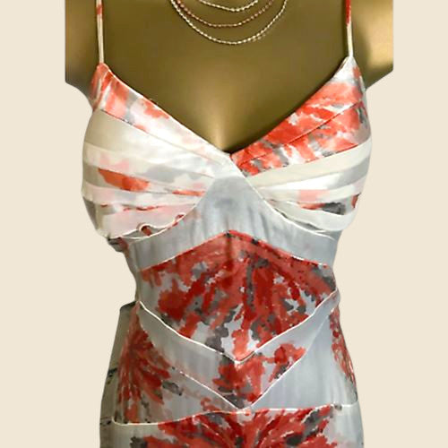 Mannequin wearing a floral dress with red, white, pattern on a beige background