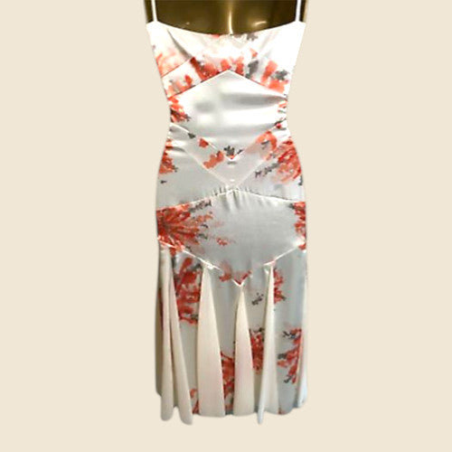White dress with red floral pattern on a beige background