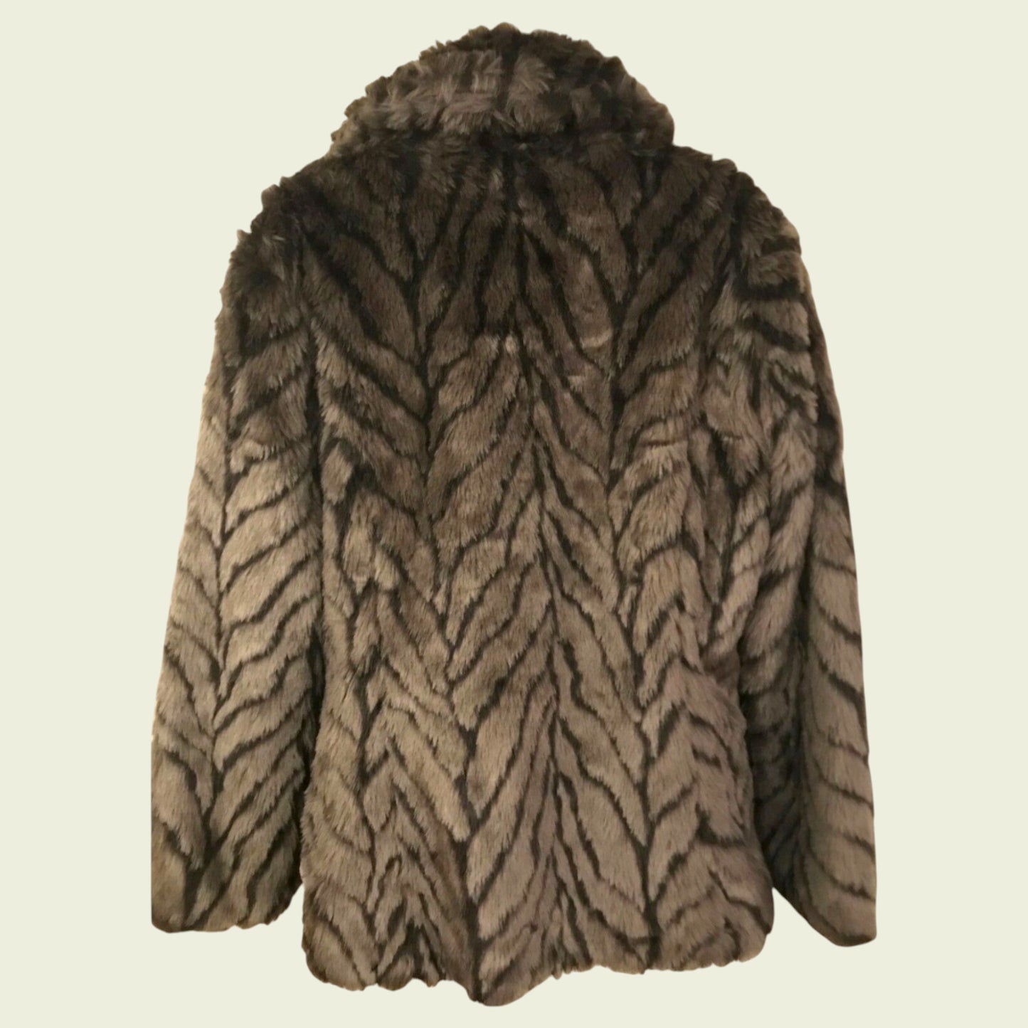 Fur coat with tiger stripe pattern on a beige background