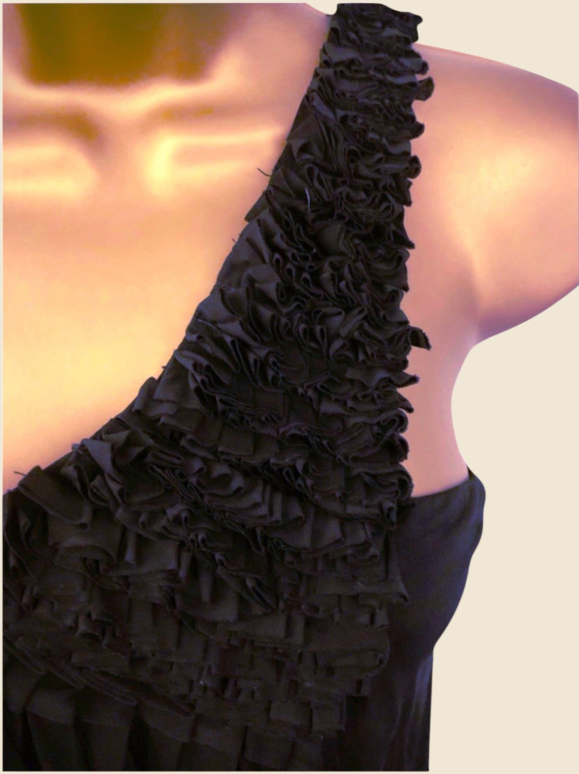 Black ruffled dress on a plain background