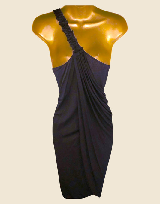 Black one-shoulder dress on a mannequin against a beige background