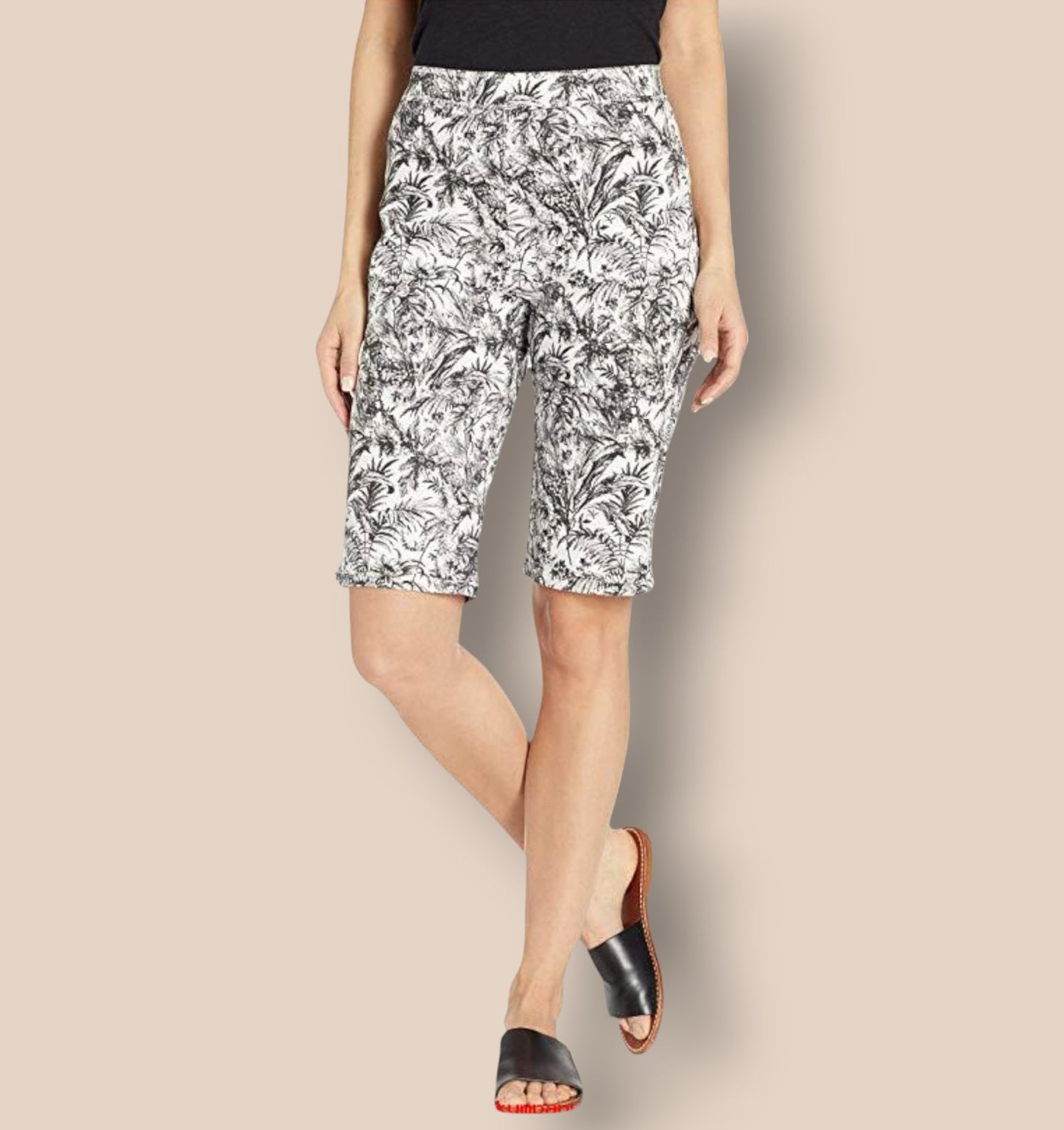 Woman wearing black and white patterned shorts on a beige background