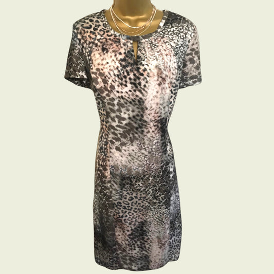 Leopard print dress on a mannequin against a plain background