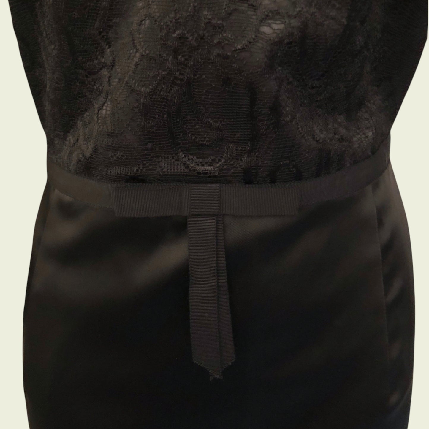 Black lace top and black skirt on a neutral background