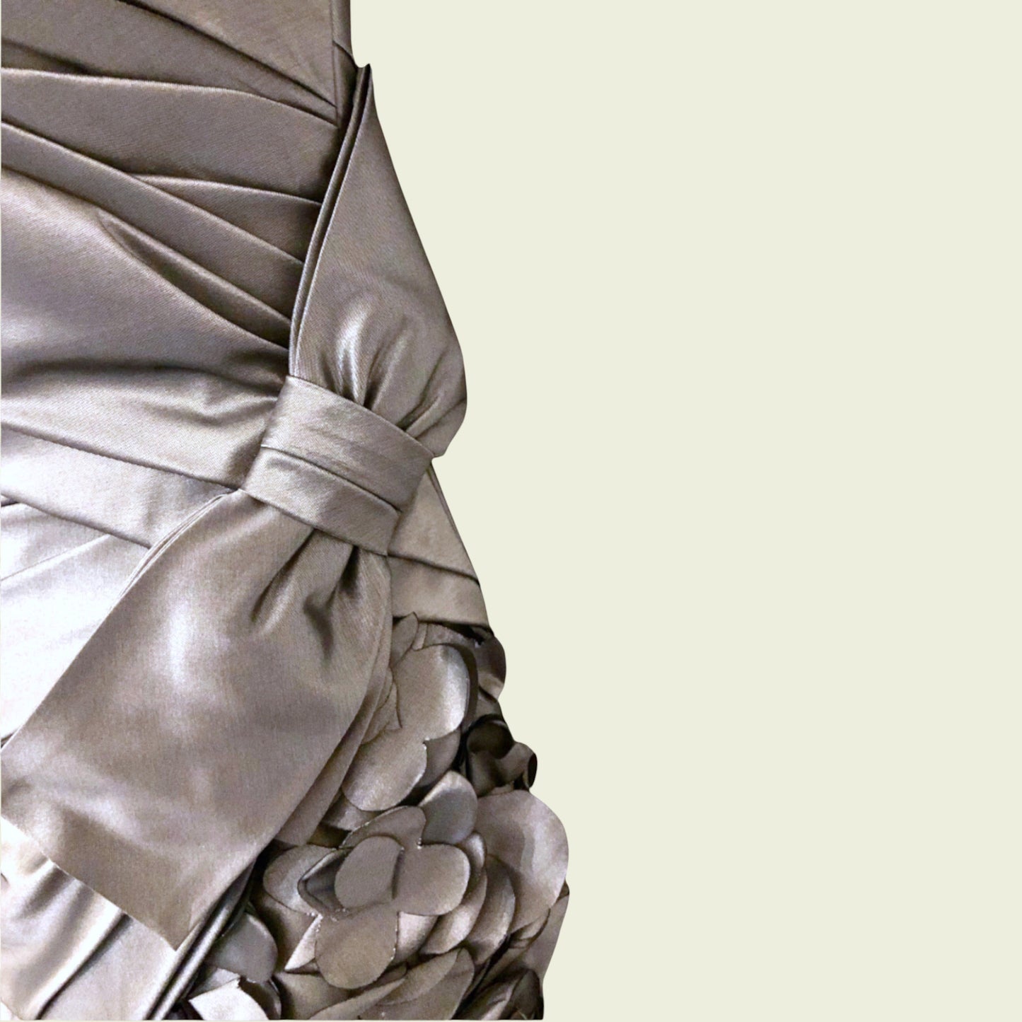 Close-up of a silver dress with floral details on a beige background