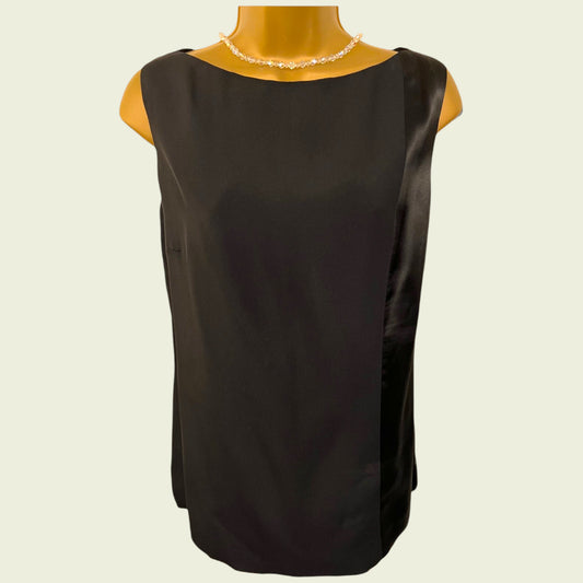 Black sleeveless top on a mannequin with a plain background