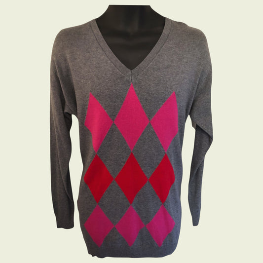 Gray sweater with pink and red diamond pattern on a mannequin against a beige background