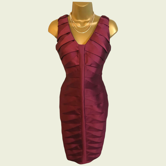 Maroon dress on a mannequin against a beige background