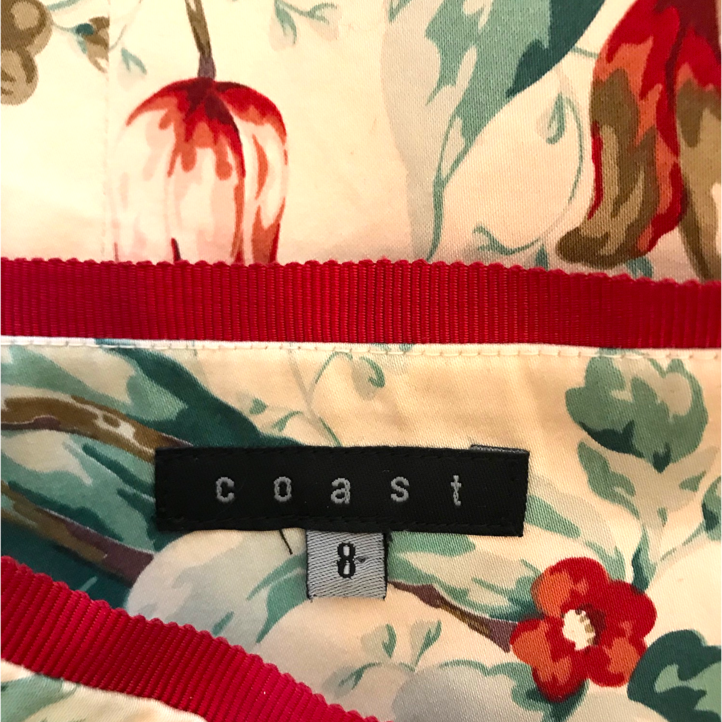 Floral-patterned fabric with a red band and 'coast' label.
